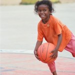 child barefoot on basketball court