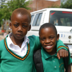 two boys in green school uniforms